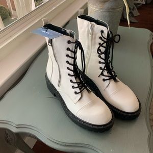 White boot with black sole lace up boot.